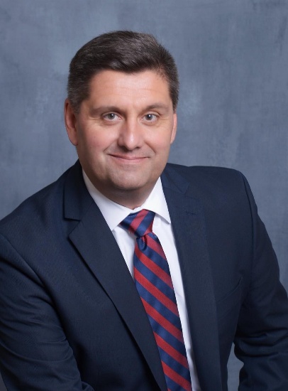A person in a suit and tieAI-generated content may be incorrect.